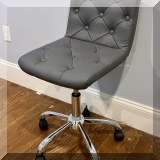 F34. Tufted faux leather desk chair. 